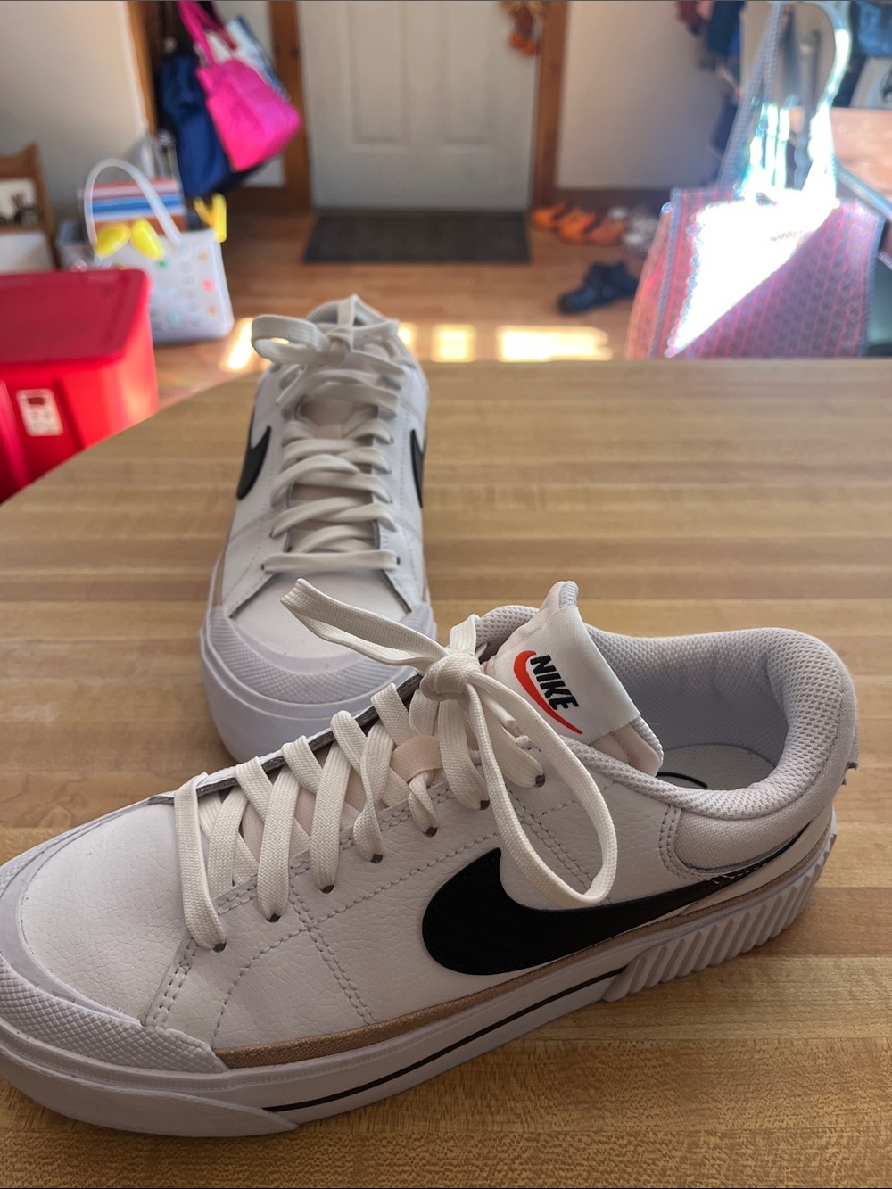 Nike White Sneakers with Black Swoosh and Tan Accent
